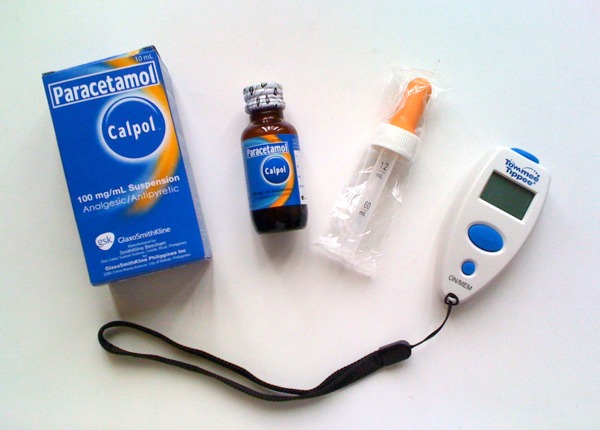 Image of paracetamol and digital thermometer for medical supplies